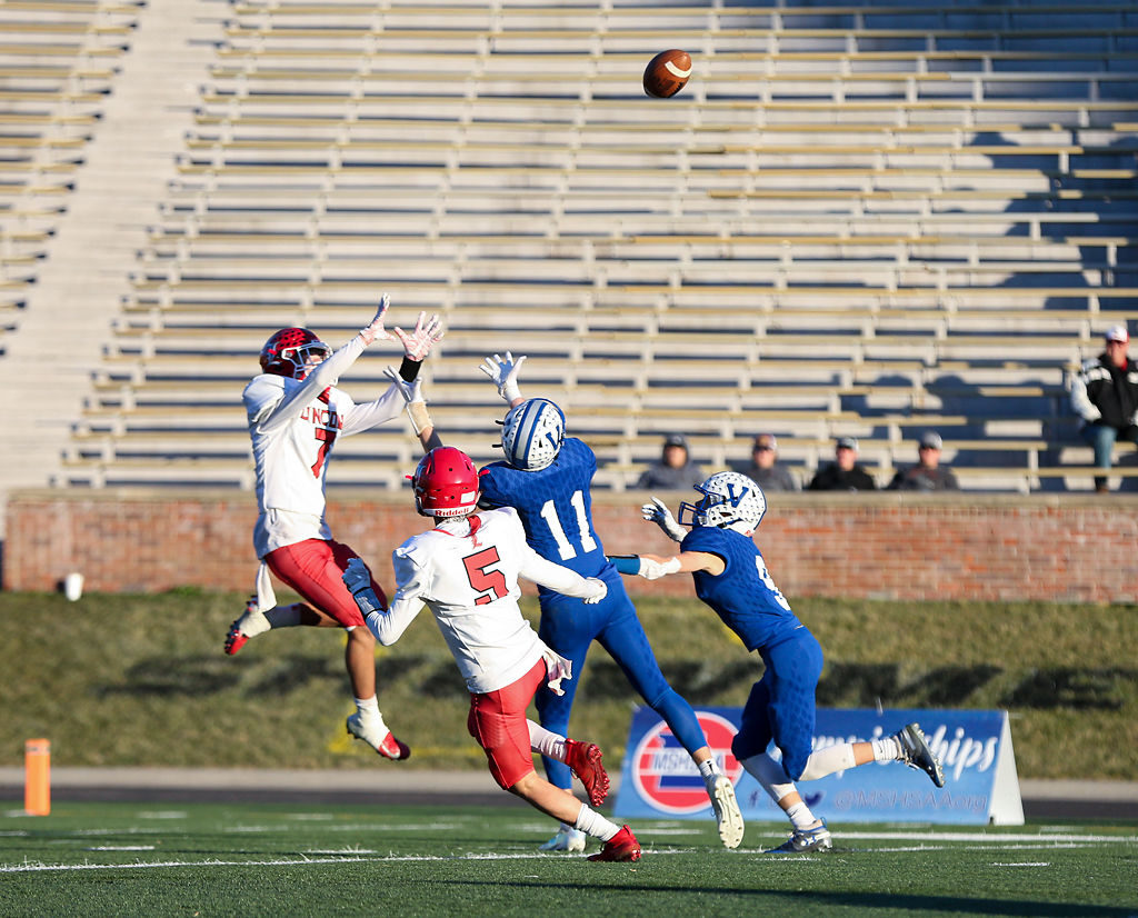 Lincoln defender Bo Kroenke reaches to intercept a pass